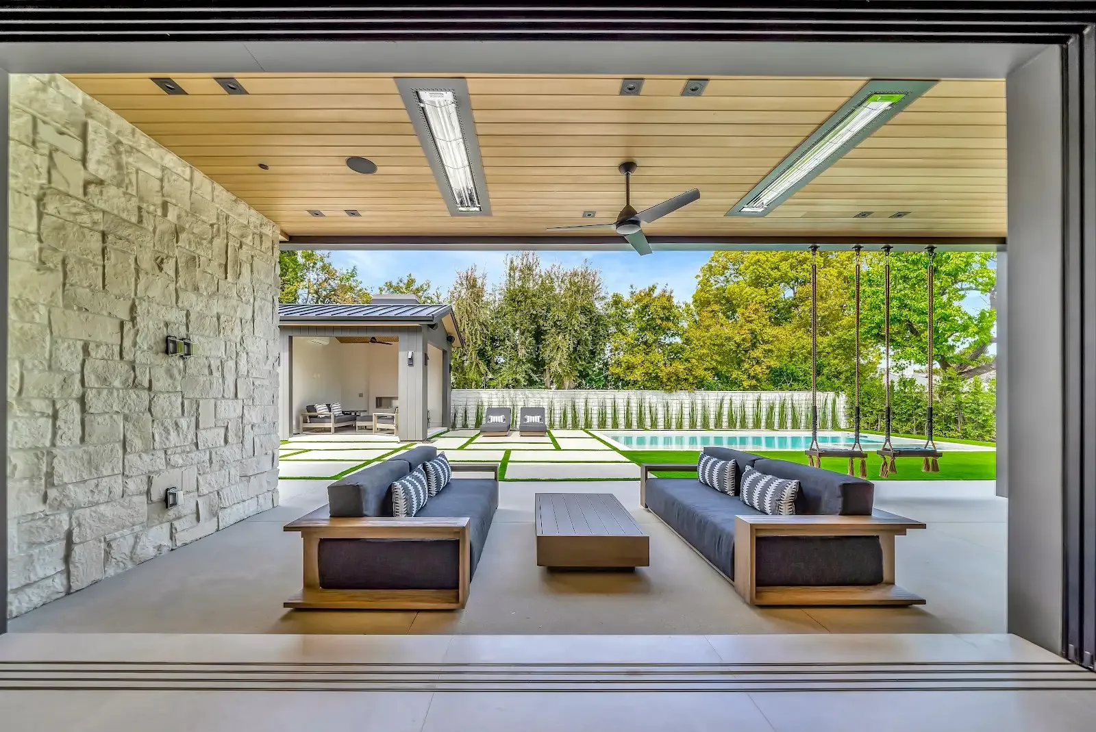 Great room opening fully onto a covered patio through sliding glass walls