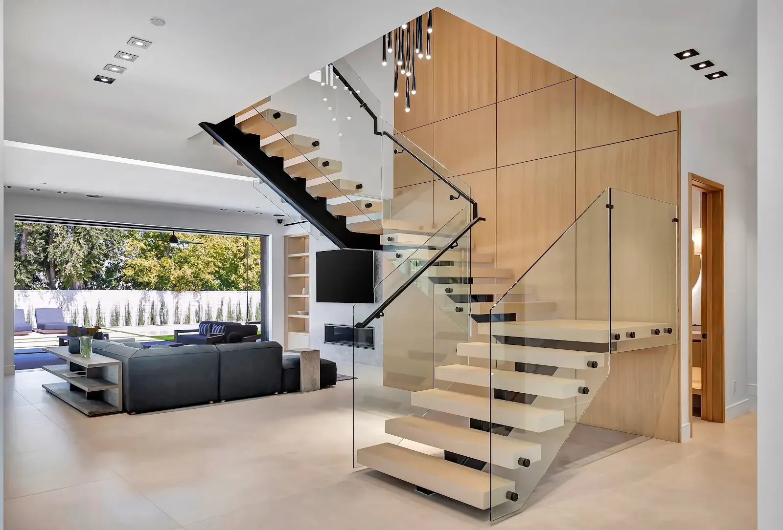 A floating white-oak staircase inside a full-home remodel