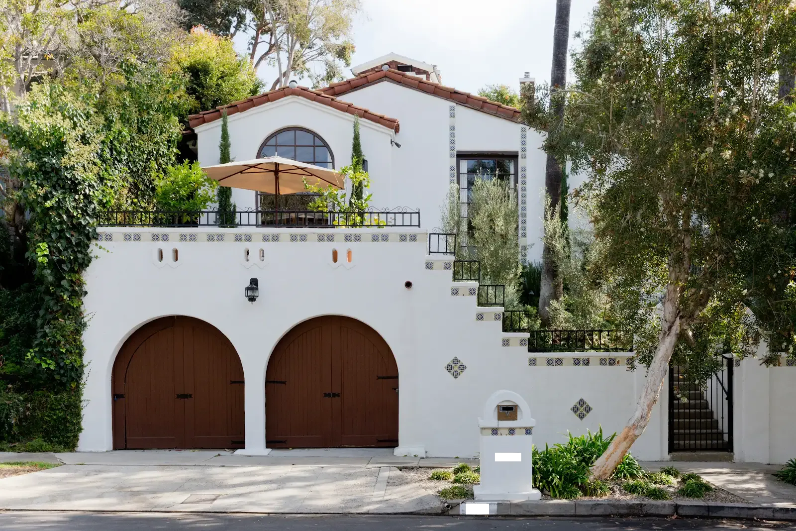 Spanish-style home with arched garage doors after a full remodel