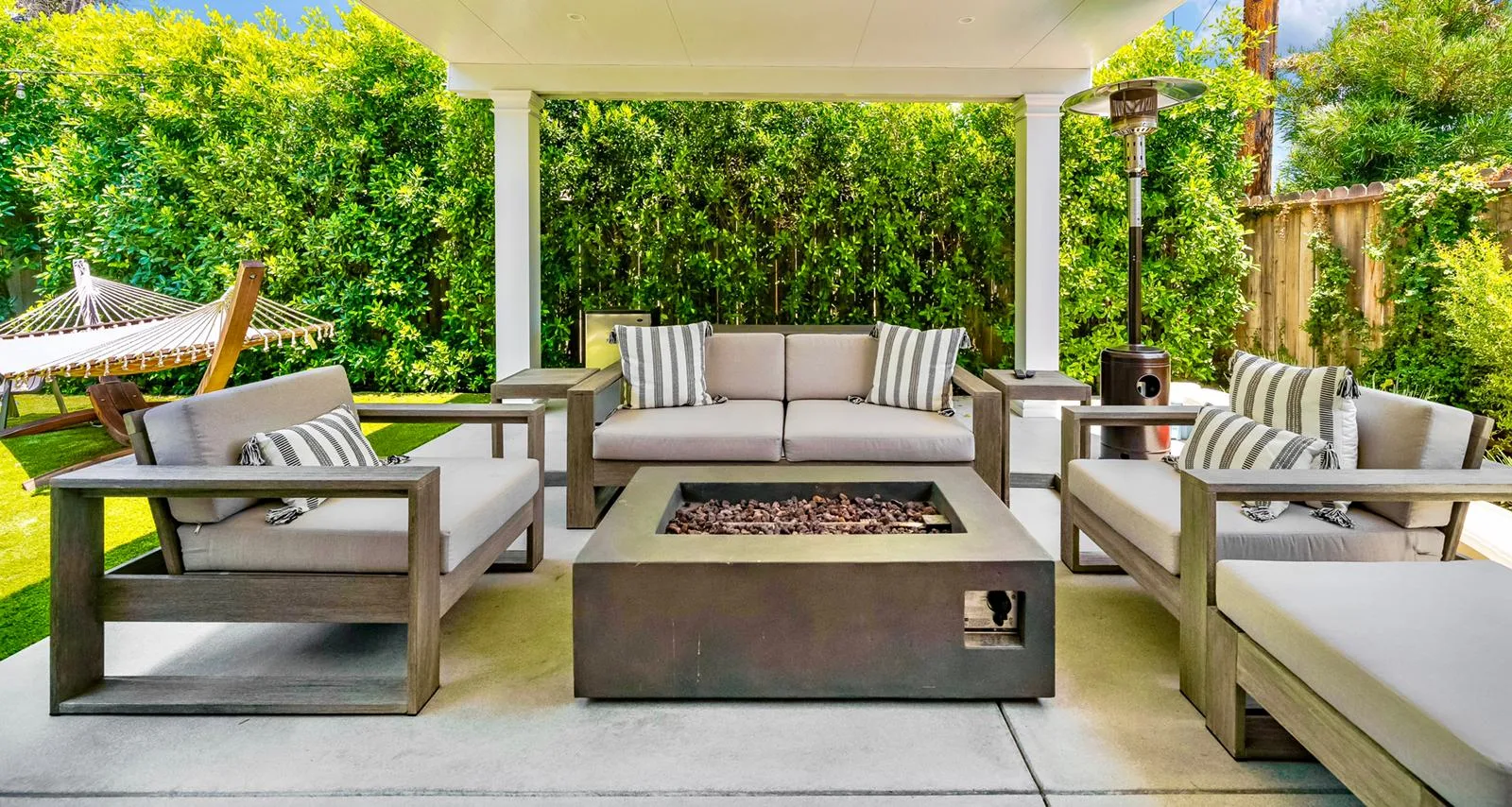 A covered patio with an outdoor kitchen